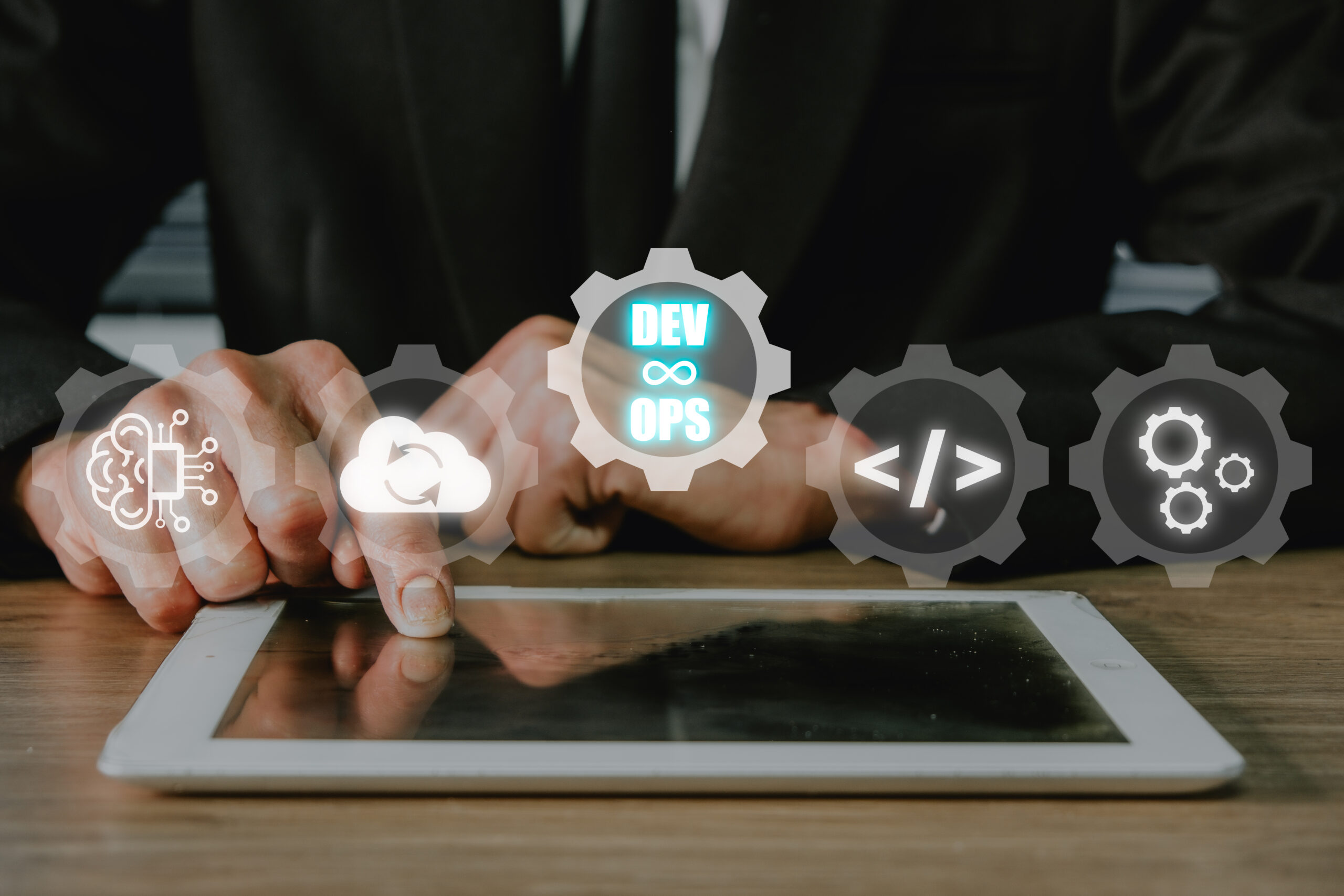 DevOps concept, Man hand touching tablet with DevOps icon on VR screen on desk, Methodology development operations agil programming technology.concept.